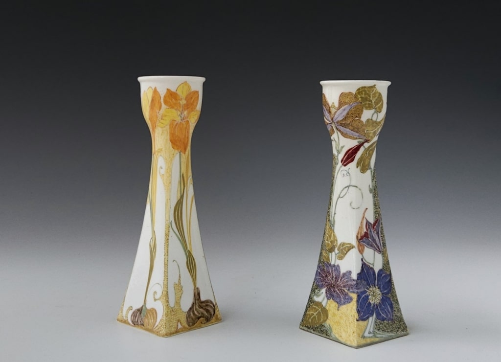 two Rozenburg eggshell porcelain candlesticks model 212p 1902 and 1905